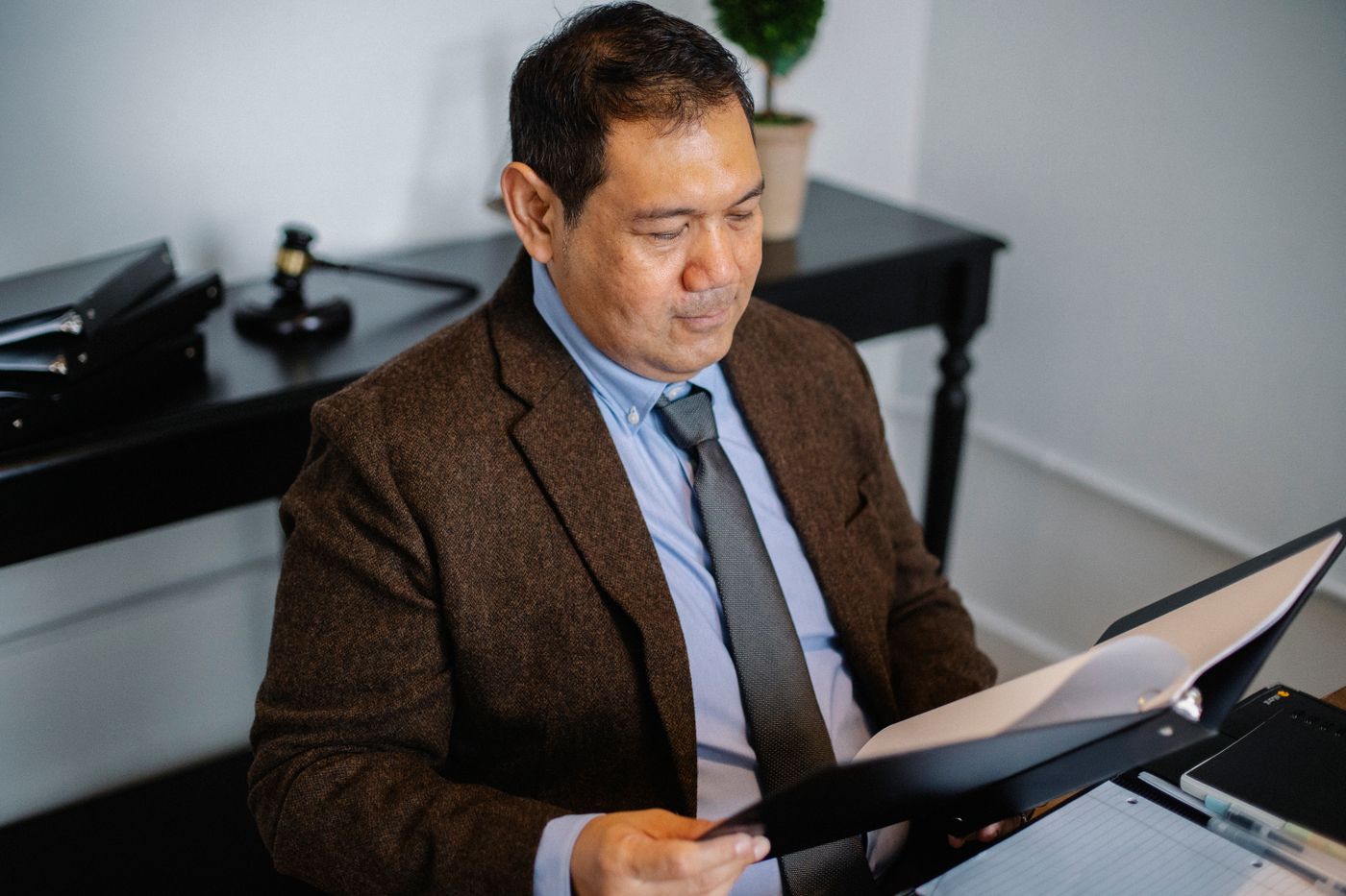 An admissions officer reading through a file at a desk