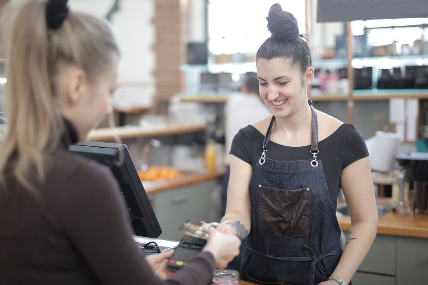 A customer paying by card at a counter