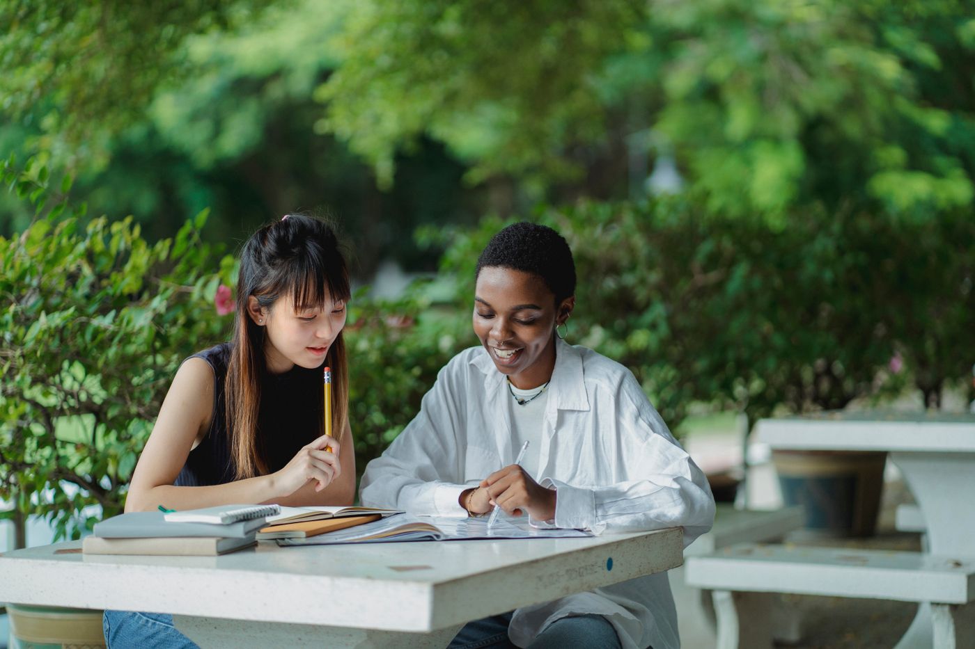 Two students working together at an outdoor table
